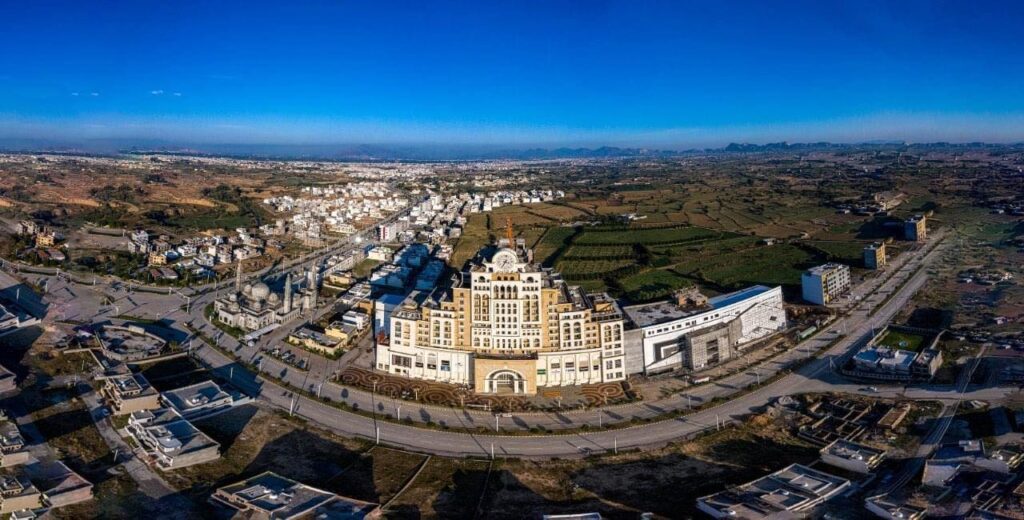 Aerial view of New City Phase 2 Wah Cantt showing wide roads and green parks
